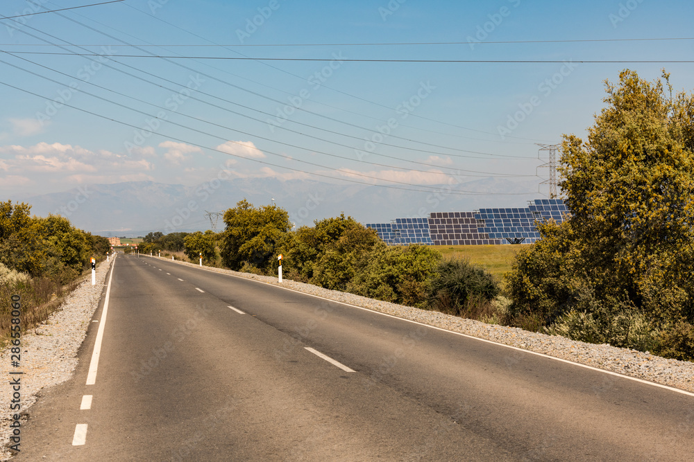 Solar panels from a photovoltaic plant next to road near Almaraz