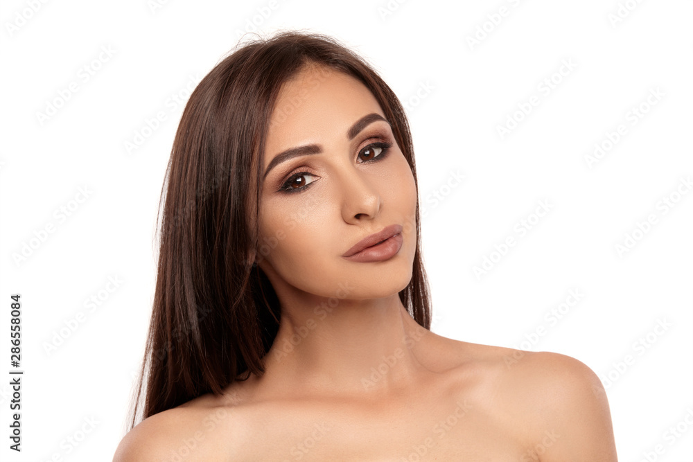 Close up portrait of a brunette nude model girl with professional evening make-up and plump lips, posing isolated on white background. Close up portrait of a brunette nude model girl with professional evening make-up and plump lips, posing isolated on white background.