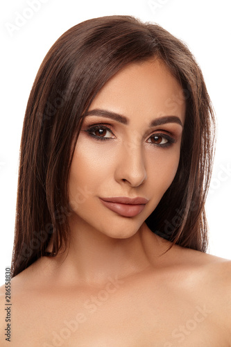 Close up portrait of a brunette nude model girl with professional evening make-up and plump lips, posing isolated on white background.