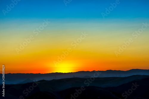 Sunrise over Silhouetted Horizon