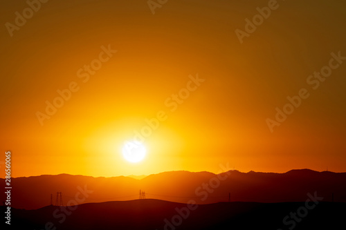 Orange Sun over Horizon, Mountains