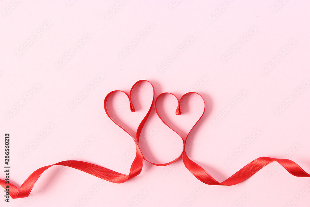 Fotografie hearts from ribbons on a colored background top view.