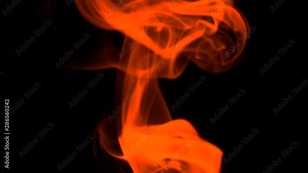 Fiery red smoke billow rising swirl up, isolated on black background. Colored smoke blowing to top. Closeup. Fiery red smoke billow rising swirl up, isolated on black background. Colored smoke blowing to top. Closeup.