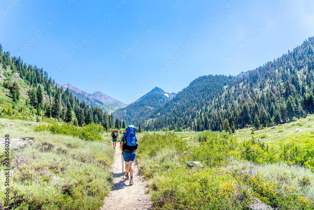 Fototapeta premium Backpackers on Trail in Mountains on Trail