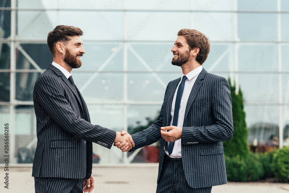 Image two business partners in elegant suit successful handshake together.Partnership approval and thanks gesture concept