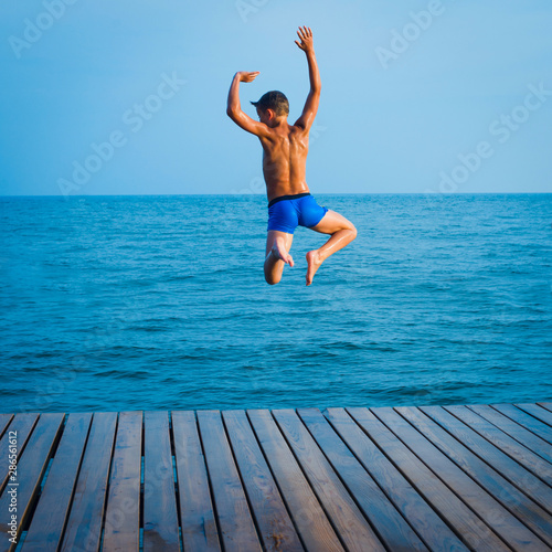 summer fun - happy kids jump to the water