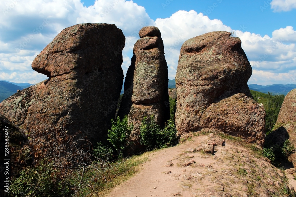 Red rock vertical pillars against blue sky in summer Red rock vertical pillars against blue sky in summer
