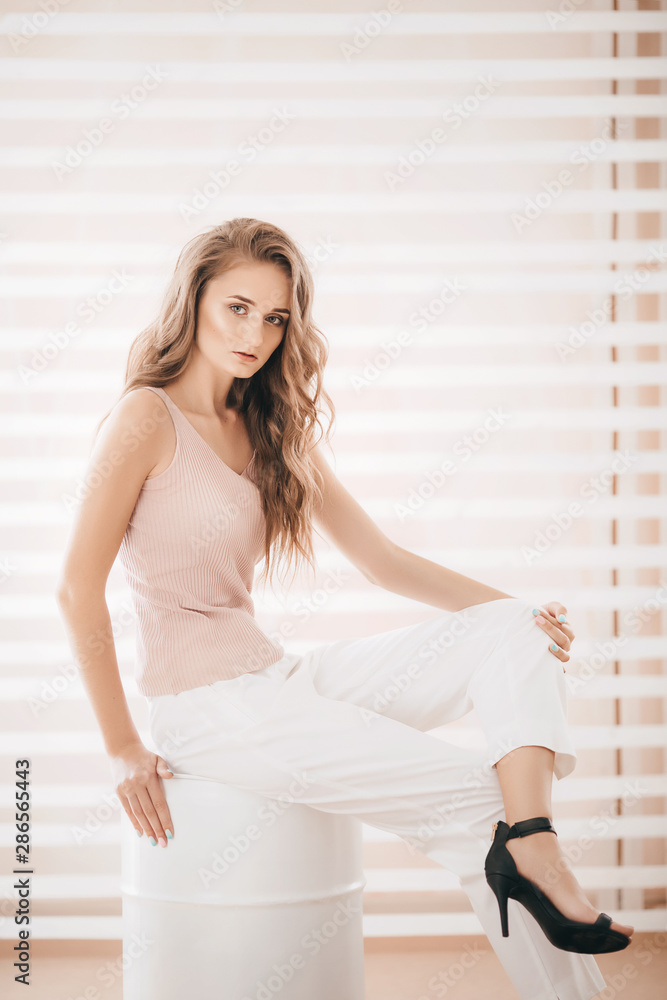 Portrait of beautiful young blonde woman with makeup in fashion clothes Portrait of beautiful young blonde woman with makeup in fashion clothes
