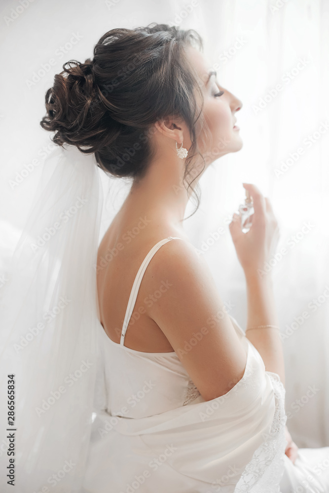 Beautiful brunette bride with stylish make-up in white dress Beautiful brunette bride with stylish make-up in white dress