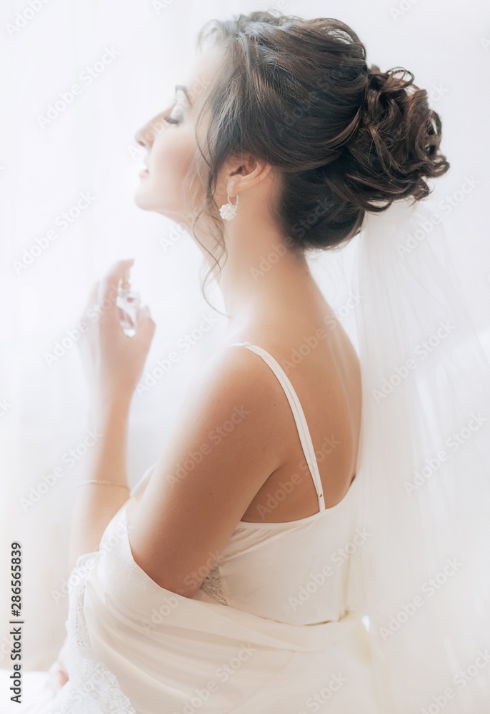 Beautiful brunette bride with stylish make-up in white dress Beautiful brunette bride with stylish make-up in white dress