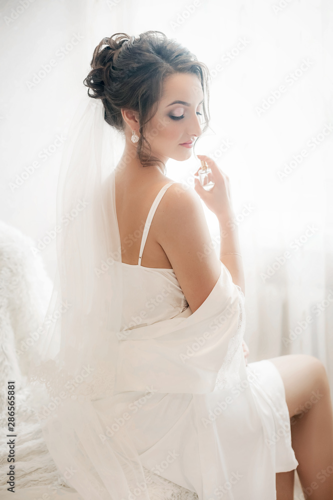 Beautiful brunette bride with stylish make-up in white dress Beautiful brunette bride with stylish make-up in white dress