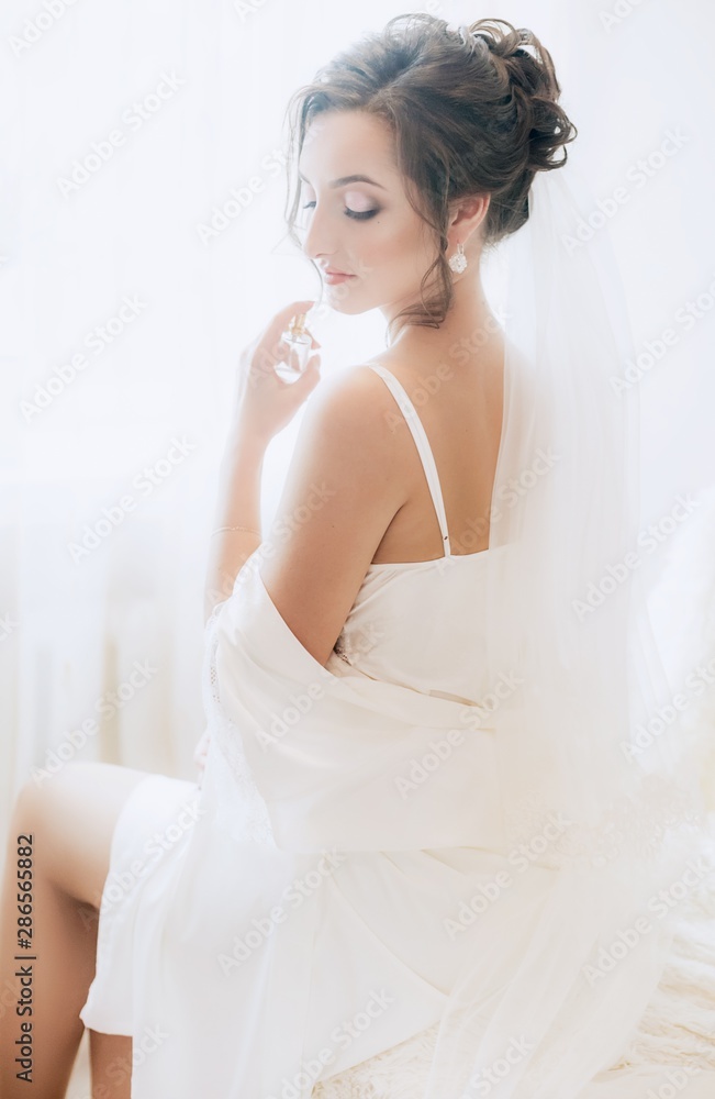 Beautiful brunette bride with stylish make-up in white dress Beautiful brunette bride with stylish make-up in white dress