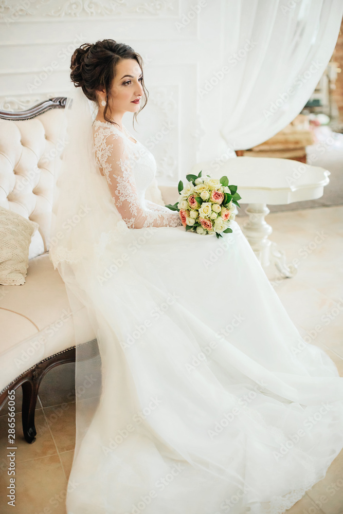 Beautiful brunette bride with stylish make-up in white dress Beautiful brunette bride with stylish make-up in white dress