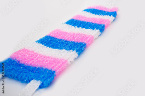 Knitted multi-colored washcloth on a white background