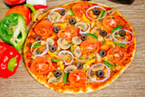 Popular colorful ingredients as like tomatoes, cheese, mushroom, capsicum, olives and other ingredients baked healthy Pizza.