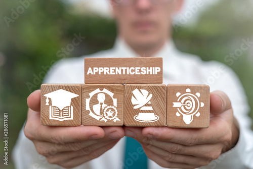 Apprenticeship on wooden blocks as education or job training concept. photo
