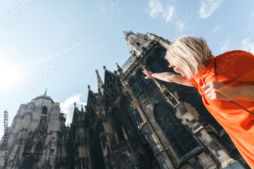 Woman stands on the background of St. Stephen's Cathedral in Vienna, Austria
