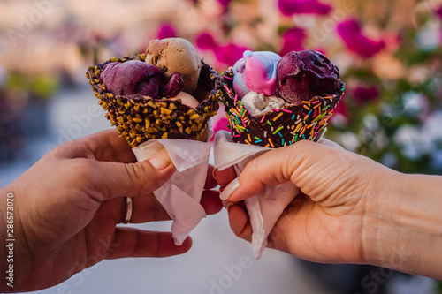 Two hands holds two ice cream cones