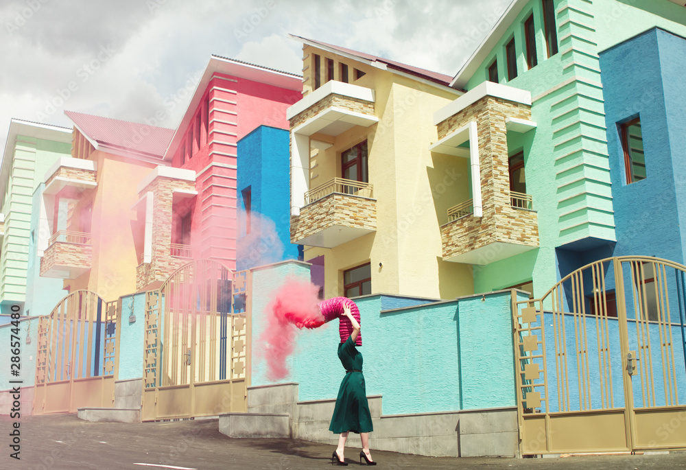 © Karen Khachaturov - Woman with pipe spraying pink powder paint on head © Karen Khachaturov - Woman with pipe spraying pink powder paint on head