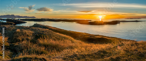 Sun setting over archipeligo of small islands surrounding the harbor at the fishing village of Stykkisholmur, in western Iceland.