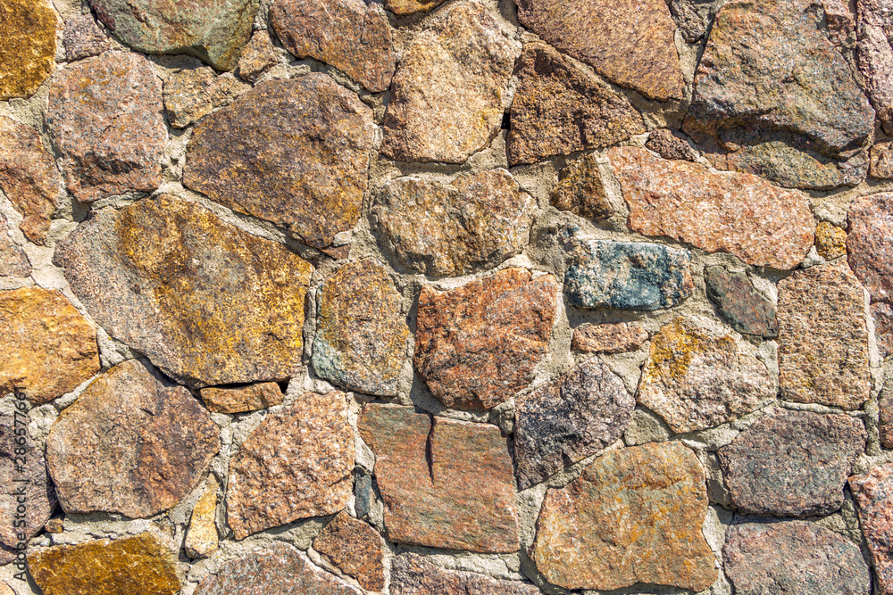 Stonewall texture of decorative masonry with large stones and boulders, like an art background. Close-up detail view. Stonewall texture of decorative masonry with large stones and boulders, like an art background. Close-up detail view.