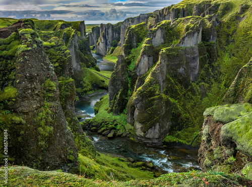 Fjaðrárgljúfur Canyon in southern Iceland. The canyon was carved through the lava and palagonite by progressive erosion by the Fjaðrá River, fed by meltwater from glaciers over millennia.