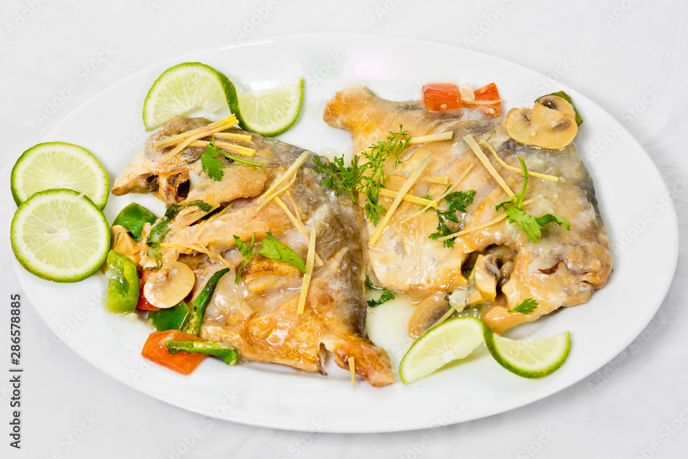 Pomfret fish pieces on plate, spicy Indian dish. Popular amongst Bengalis and south Asia for it's taste.