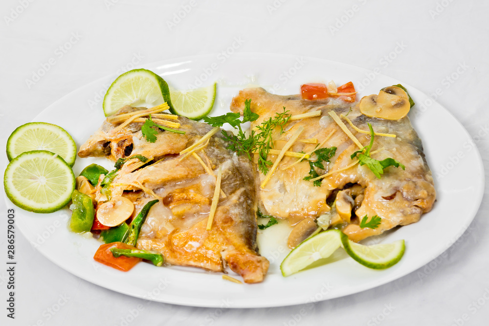 Pomfret fish pieces on plate, spicy Indian dish. Popular amongst Bengalis and south Asia for it's taste. Pomfret fish pieces on plate, spicy Indian dish. Popular amongst Bengalis and south Asia for it's taste.