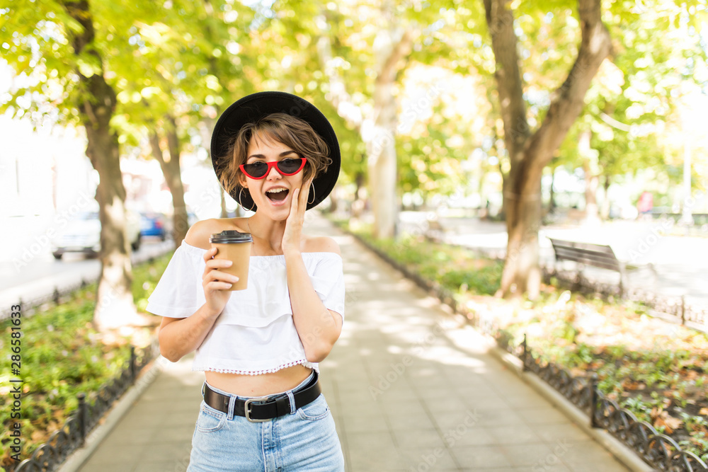 Young woman in the street drinking morning coffee Young woman in the street drinking morning coffee