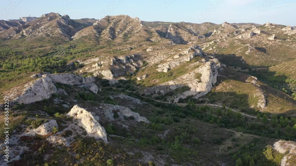 Drone slowly tracking over the rocky landscape of Alpilles natural regional park, Southern France Drone slowly tracking over the rocky landscape of Alpilles natural regional park, Southern France
