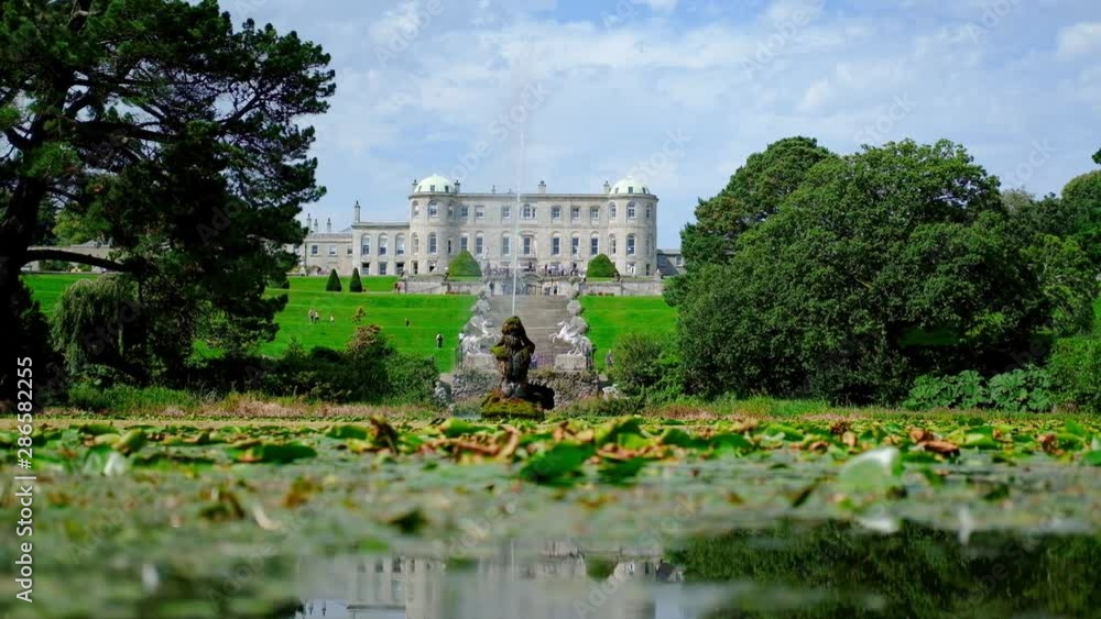 Powerscourt House & Gardens low angle mirrored view of manor house across fountain lake reflections. Powerscourt House & Gardens low angle mirrored view of manor house across fountain lake reflections.