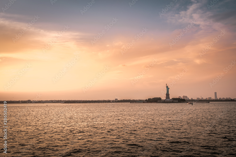 Sunset at the Statue of Liberty of New York in the US on a ride on the Staten Island Ferry Sunset at the Statue of Liberty of New York in the US on a ride on the Staten Island Ferry