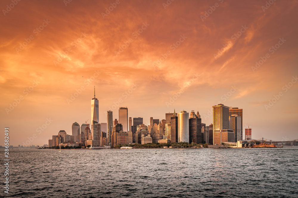 New York City New Jersey, NYC/ USA - 08 21 2017: Amazing sunset on New York City Hudson River on public transport staten island ferry with beautiful panorama view to NYC Manhattan skyline