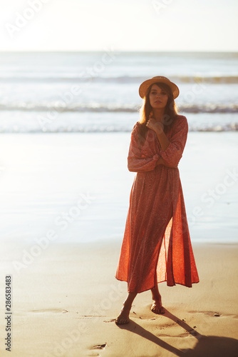 Close up portrait of beautiful young woman on the beach. Young caucasian female model on the sea shore.