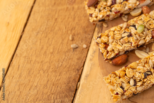 granola bars on a wooden background with space for design, horizontal photo