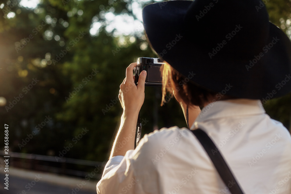 The girl in the black hat shooting in an old european town. The girl in the black hat shooting in an old european town.