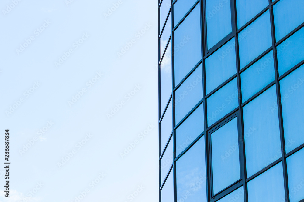 glass panoramic windows with reflection of blue sky and tree in summer glass panoramic windows with reflection of blue sky and tree in summer