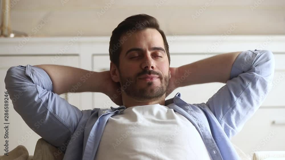 Close up european guy put hands behind head resting Close up european guy put hands behind head resting