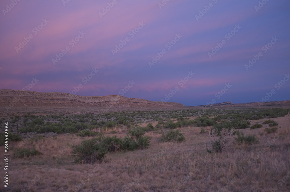 Fototapeta premium Sunset over bluff, south of Meeteetse, Wyoming on Highway 120
