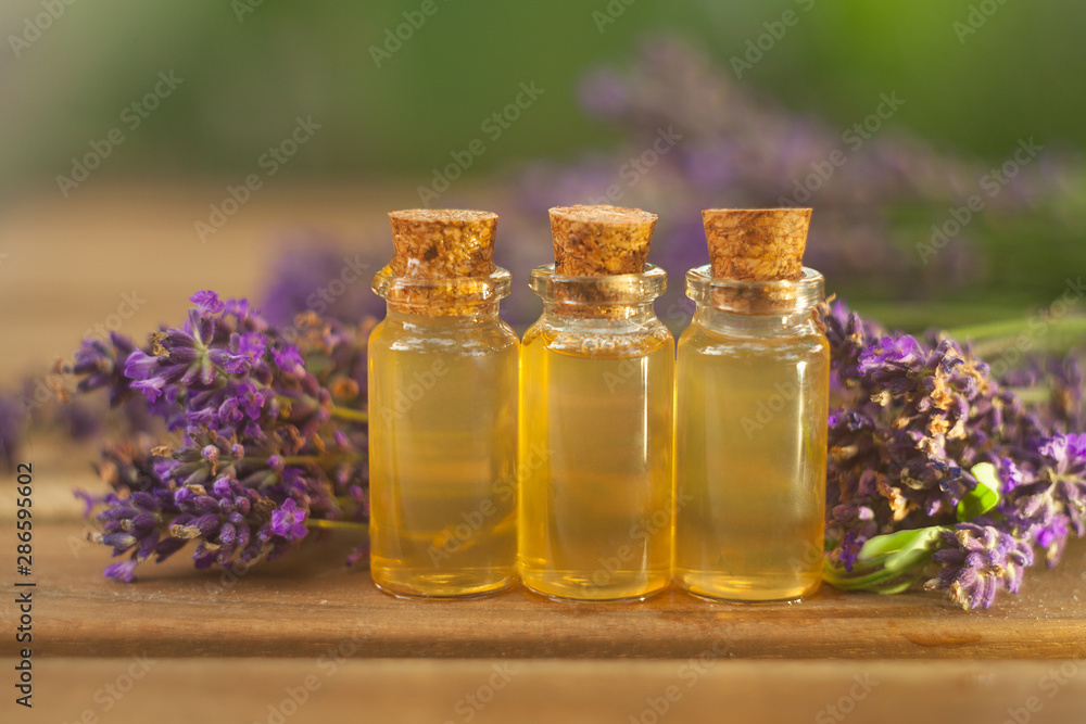 lavender essential oil in beautiful bottle on table lavender essential oil in beautiful bottle on table