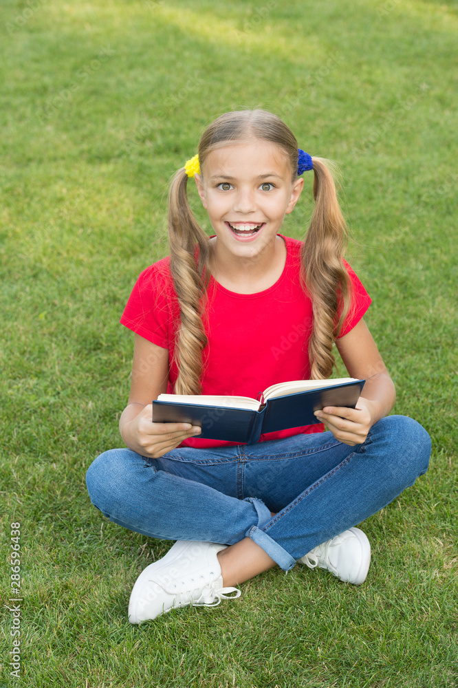 Time for great stories. Little child reading book outdoors. Schoolgirl read stories while relaxing green lawn. Cute pupil enjoy reading. School time. Interesting stories for kids. Study with pleasure Time for great stories. Little child reading book outdoors. Schoolgirl read stories while relaxing green lawn. Cute pupil enjoy reading. School time. Interesting stories for kids. Study with pleasure