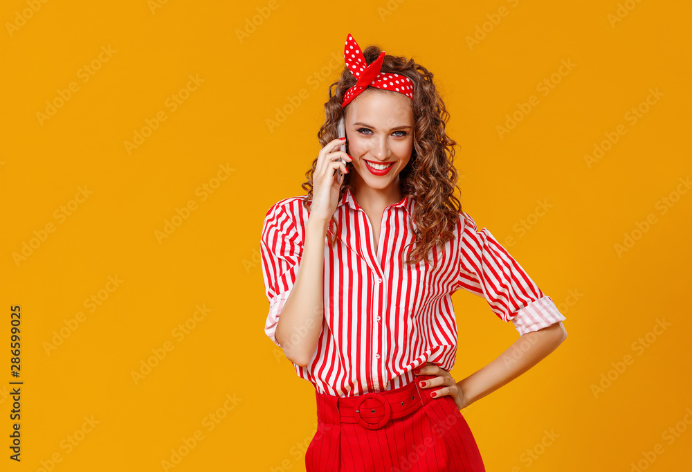 funny cheerful woman with phone on yellow background