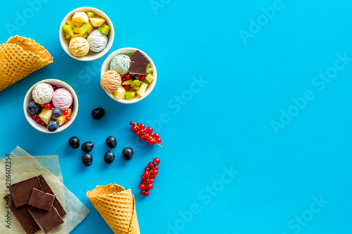 summer dessert with ice cream, chocolate and wineberry on blue backgroung top view mock up