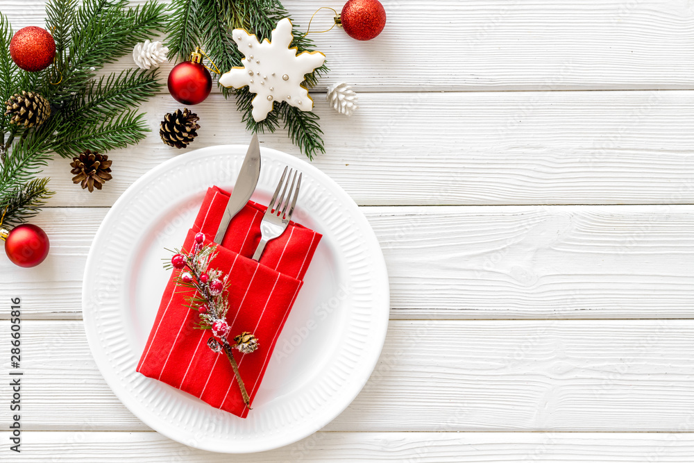 Christmas table setting with fir tree and toys on white wooden background top view space for text Christmas table setting with fir tree and toys on white wooden background top view space for text
