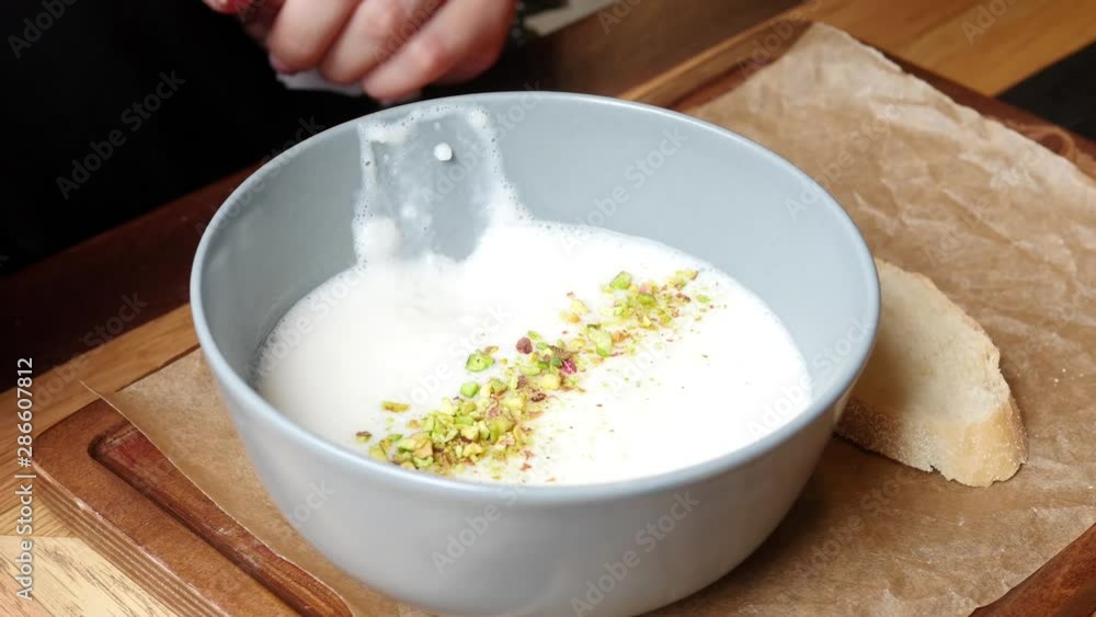 Eating a healthy breakfast. Useful porridge with nuts in soy milk. Clean food, diets, vegan food Eating a healthy breakfast. Useful porridge with nuts in soy milk. Clean food, diets, vegan food