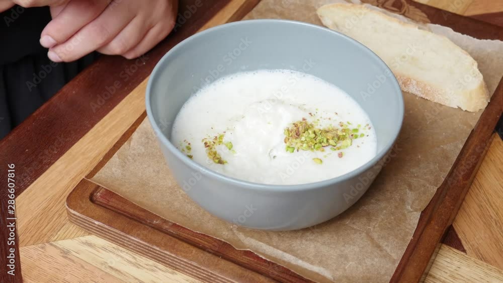 Eating a healthy breakfast. Useful porridge with nuts in soy milk. Clean food, diets, vegan food Eating a healthy breakfast. Useful porridge with nuts in soy milk. Clean food, diets, vegan food