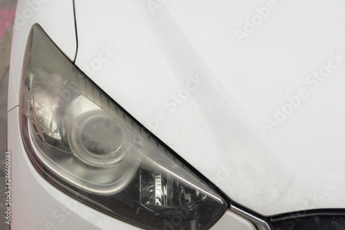 Obraz na plátně headlights of the car dim from working a long time,blurred headlights on the car,Damaged and blurred headlight surface as a result of weather condition and aging of a car