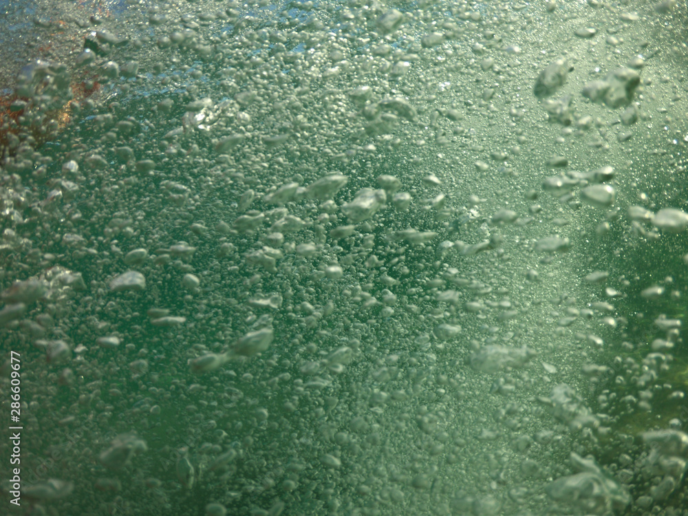 Underwater air bubbles as seen at sea rising at surface level Underwater air bubbles as seen at sea rising at surface level