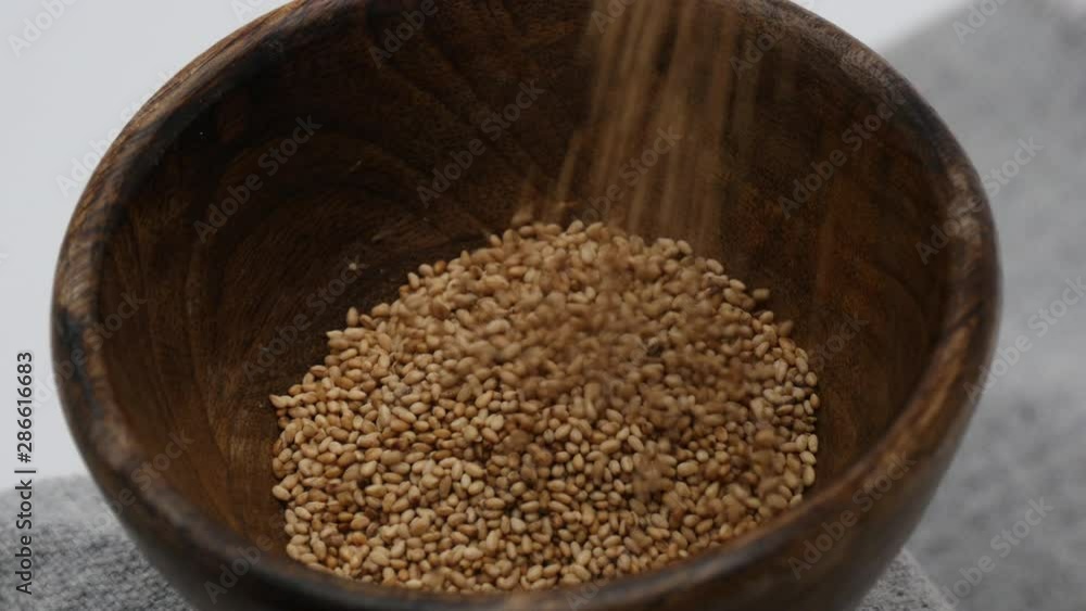 Filling much of sesames on wooden bowl Filling much of sesames on wooden bowl