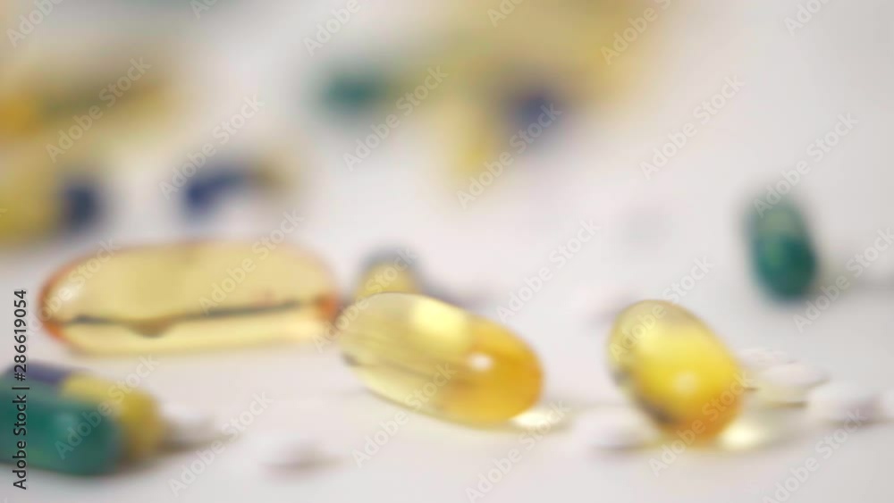 Macro Slide of Pill Varieties Strewn on White Background Macro Slide of Pill Varieties Strewn on White Background